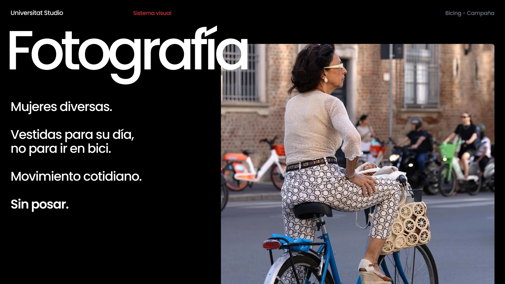 Woman in everyday clothes riding a bicycle along a city street
