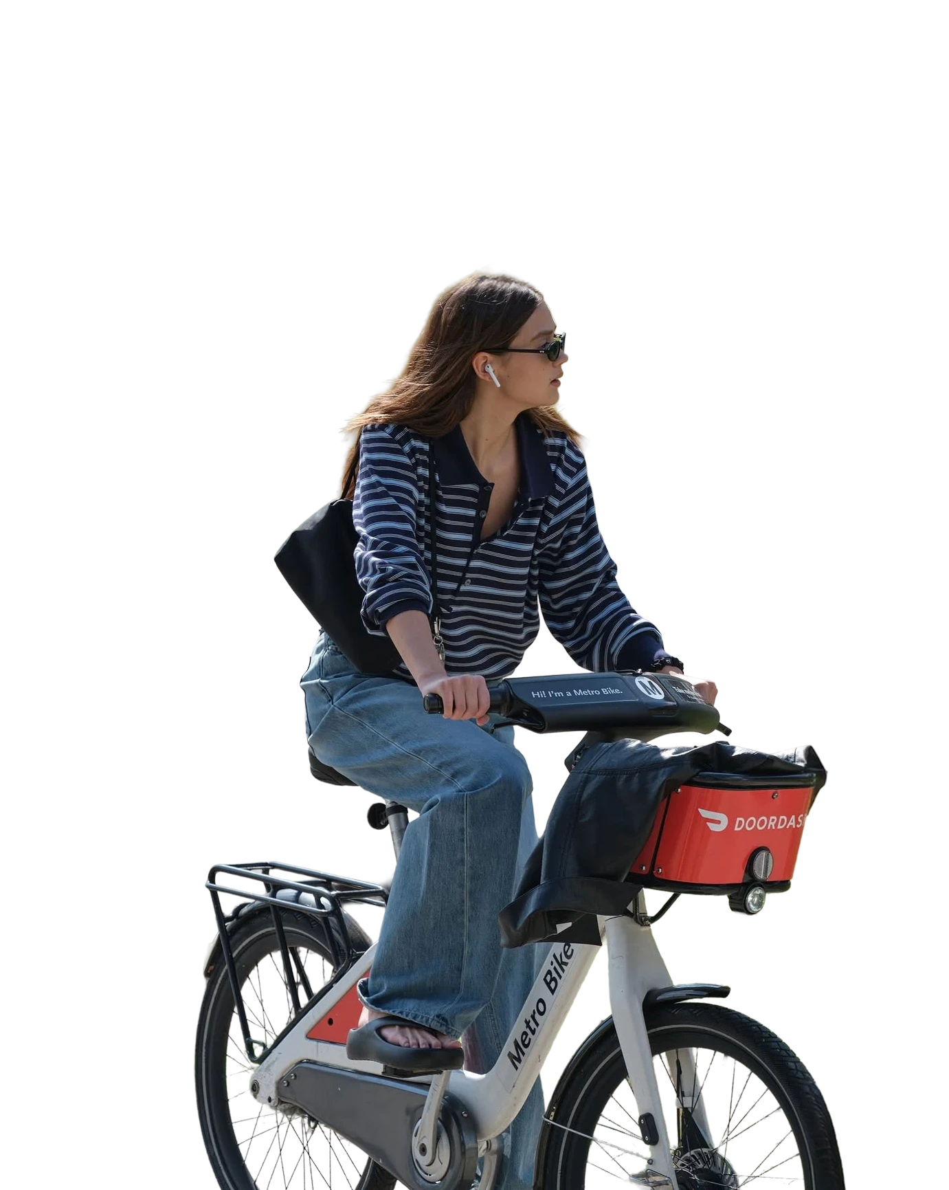 Woman riding a shared bicycle through a park